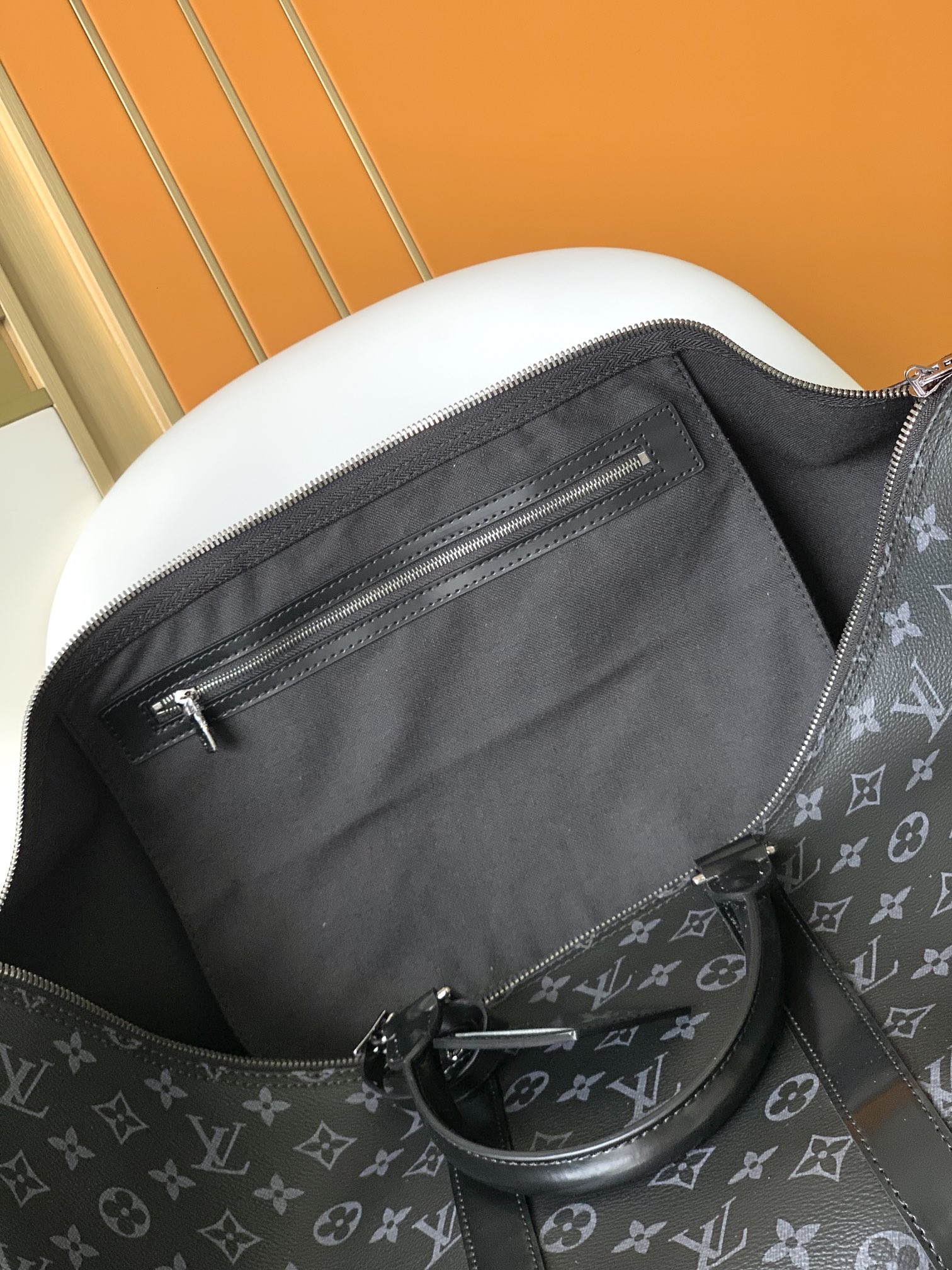 Louis Vuitton's LV latest model, a classic iconic black grey canvas travel bag, made of cut canvas